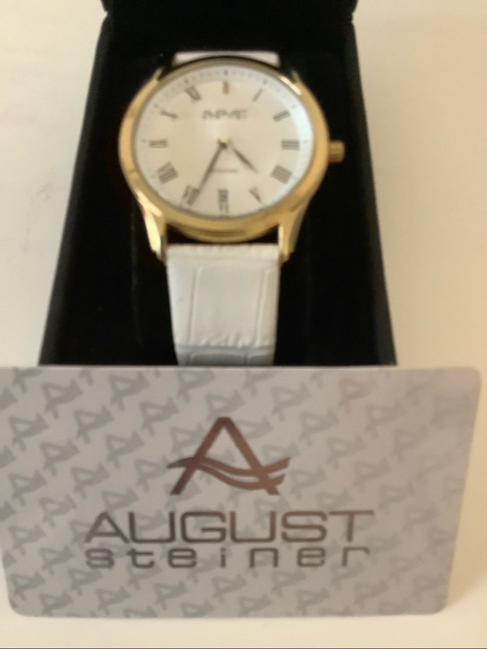August Steiner diamond watch. New. White leather band.
